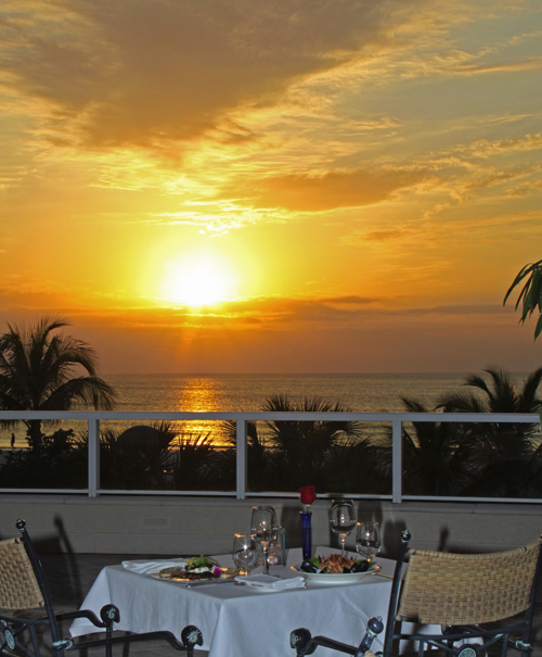 A romantic dinner for two, complete with red rose and spectacular sunset, at Sale e Pepe at Marco Ocean Beach Resort